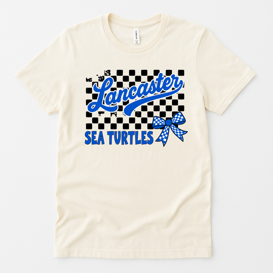Lancaster Sea Turtles shirt with checkered background, blue bow, and varsity script – natural color flat lay
