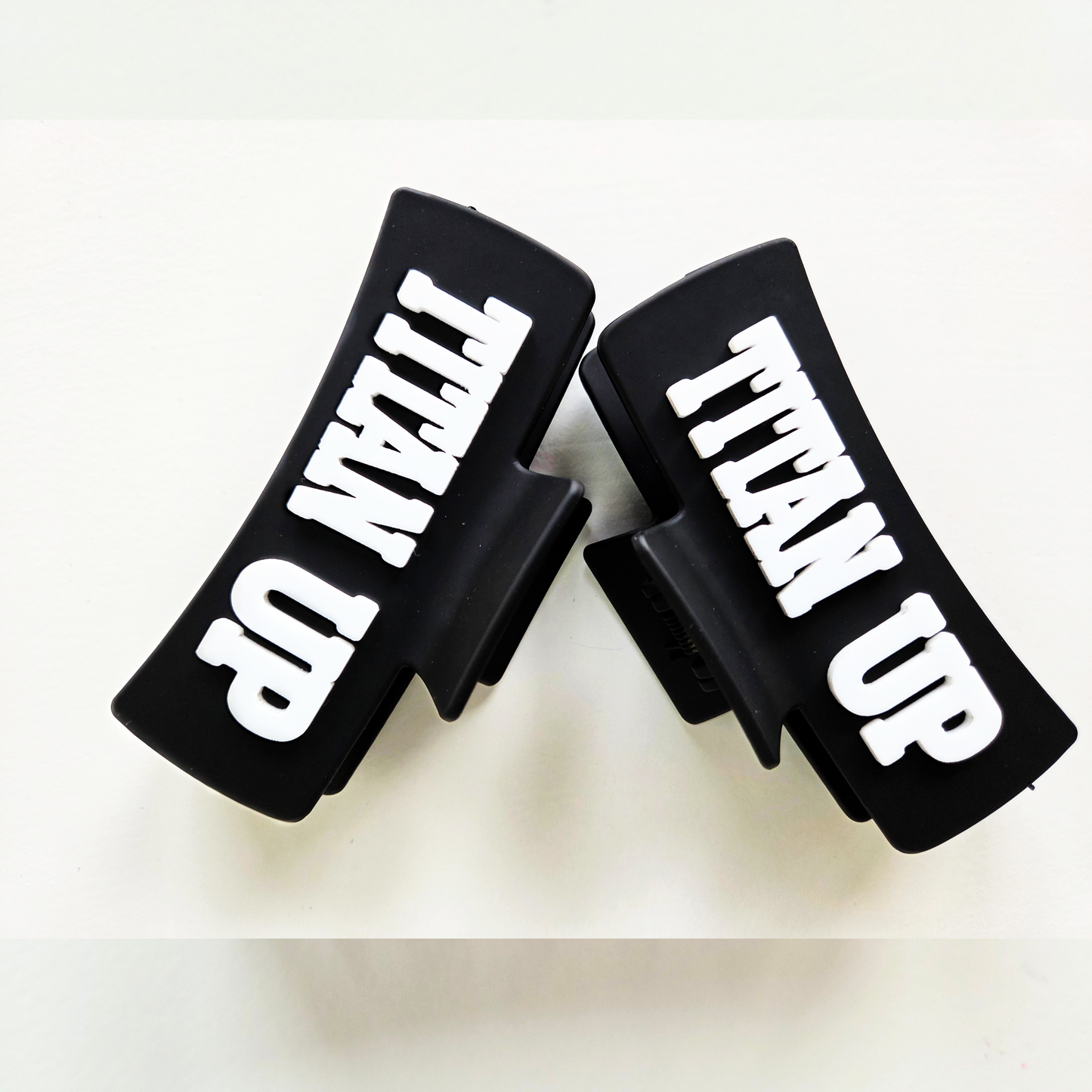 Titan Up white lettering on black claw clip