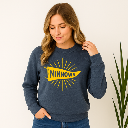 Woman wearing a navy sweatshirt with 'MINNOWS' design on a plain background