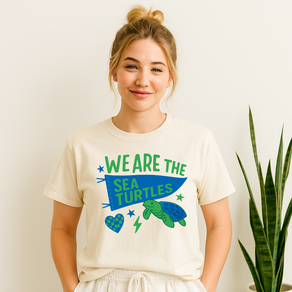 Woman wearing “We Are the Sea Turtles” pennant mascot T-shirt in school colors