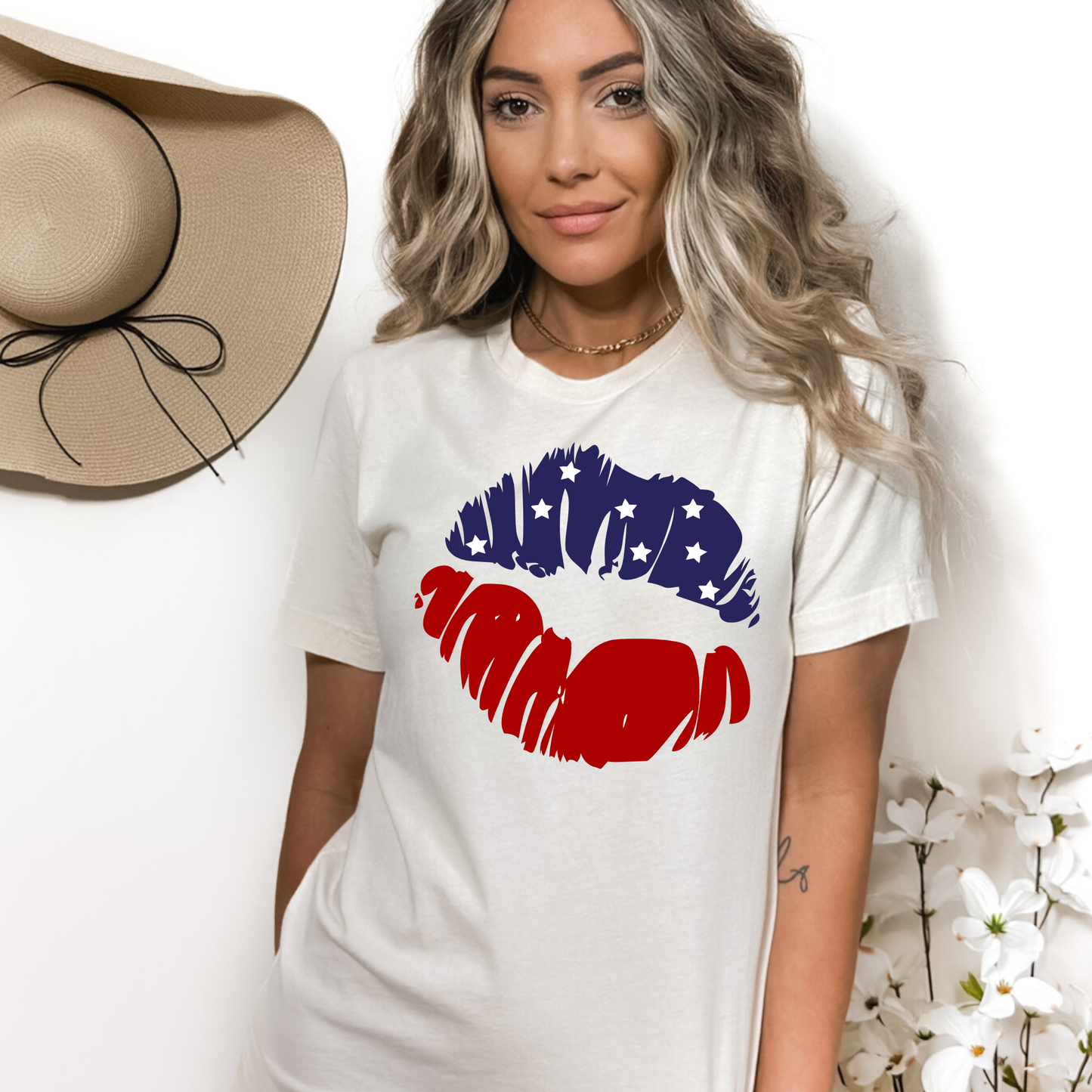 Cream colored crew neck tee with lips in red and blue with stars.