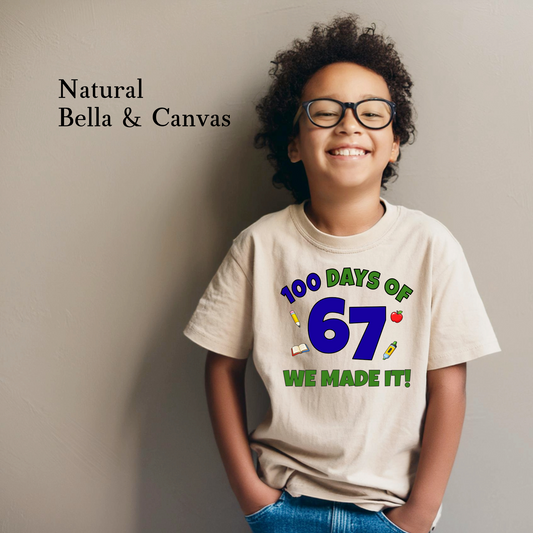 Child wearing a t-shirt with '100 Days of 67 We Made It!' text, standing against a plain background.