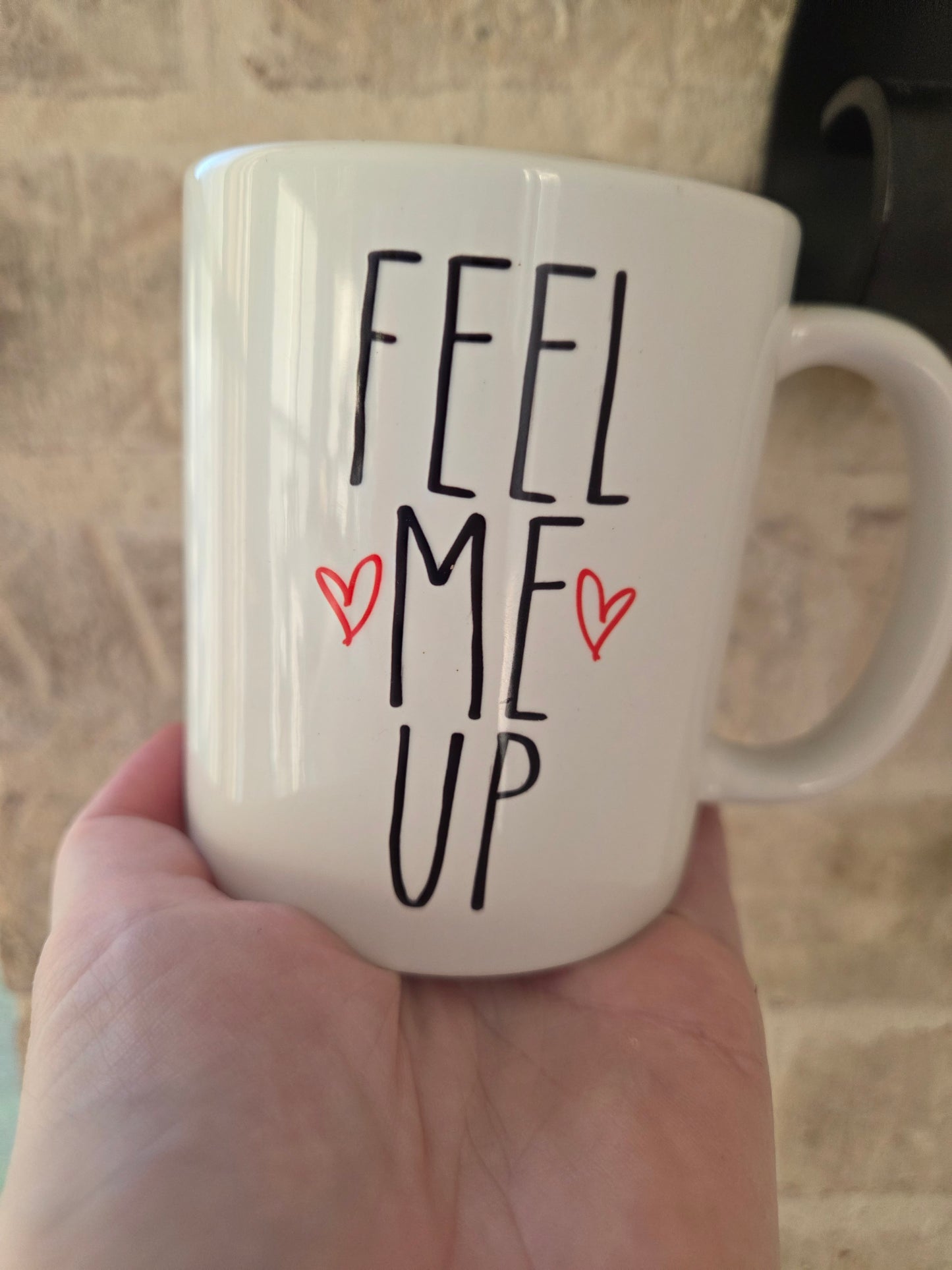 White coffee mug with Feel Me Up phrase and hearts