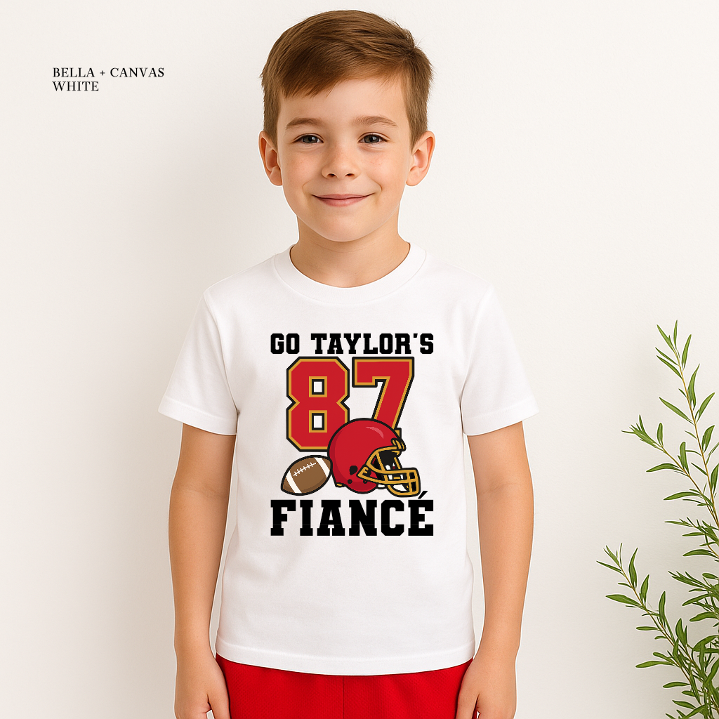 Boy wearing Go Taylor’s Fiancé 87 football T-shirt in white