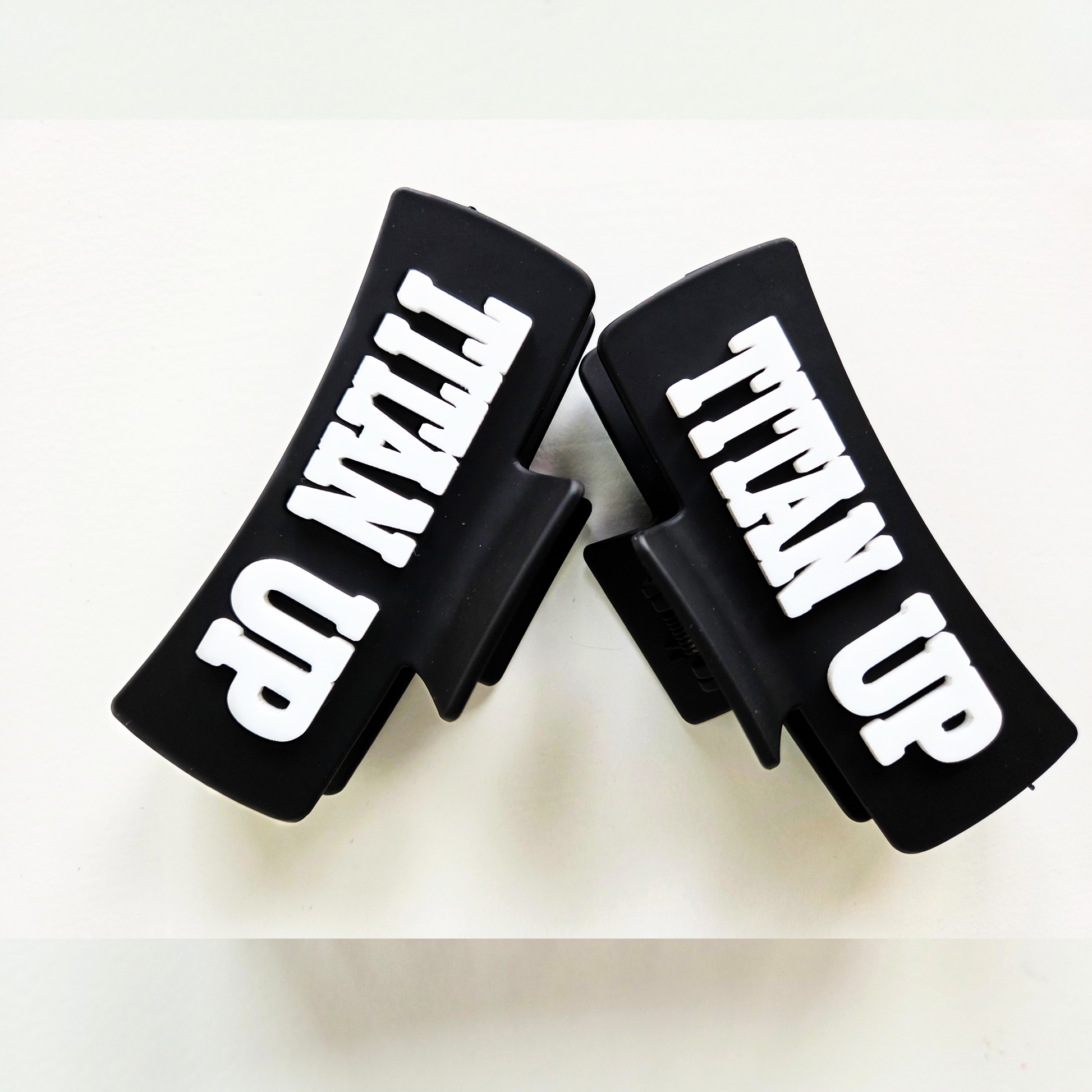 Titan Up white lettering on black claw clip