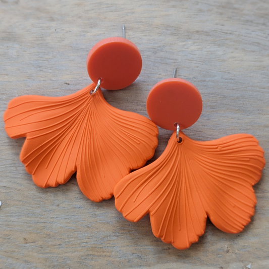 "Bold orange acrylic fan statement earrings inspired by The Life of a Showgirl"
