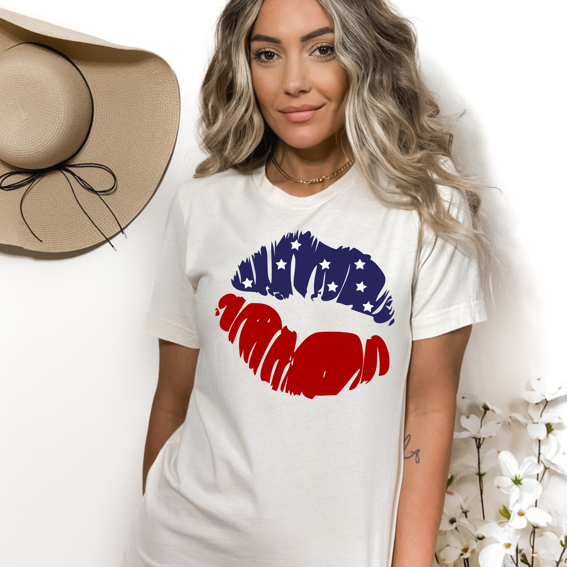 Cream colored crew neck tee with lips in red and blue with stars. 